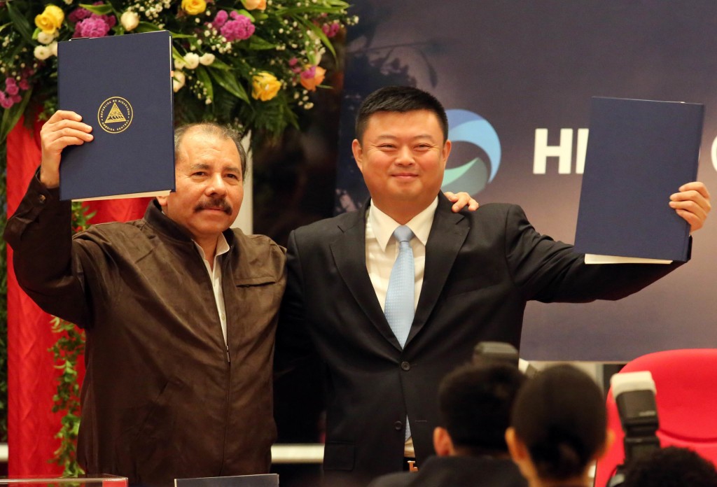 Nicaraguan President Daniel Ortega (L) stands with Wang Jing, president of of the Chinese company HK Nicaragua Development Gran Canal Interoceanico,  during the framework agreement for the construction of the Interoceanic Grand Canal in Managua, on June 14, 2013. Nicaraguan lawmakers approved a controversial deal that would allow a Hong Kong company to build a $40 billion oceanic waterway to rival the Panama Canal, and then manage it for the next 50 years. Environmental activists fear the worst for Lake Nicaragua, which the planned waterway will pass through. AFP/Inti OCON