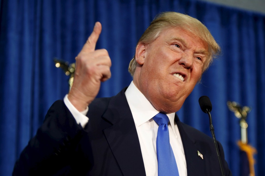 Republican presidential candidate Donald Trump gestures and declares "You're fired!" at a rally in Manchester, New Hampshire, in this June 17, 2015 file photo.  NBC Universal is ending its business relationship with real estate mogul Trump "due to the recent derogatory statements," CNBC said in a tweet.   REUTERS/Dominick Reuter/Files