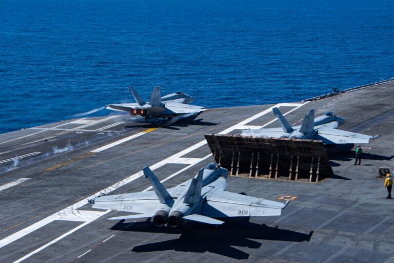 A massive US aircraft carrier navigating near the Panama Canal to enhance bilateral security.