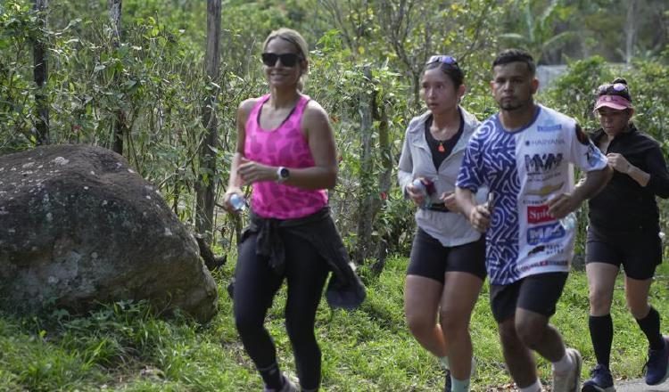 Athletes participating in the Boquete Coffee Half Marathon near a coffee plantation in Panama.