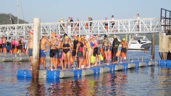 Athletes practicing nautical sports tourism in the Panama Canal waters during a sustainable travel event.