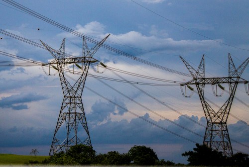 A modern wind turbine and hydroelectric dam representing Panama energy contracts and sustainable power supply.