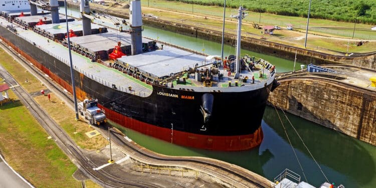 Large container ship passing through the locks without facing any Panama Canal transit restrictions due to stable water levels.