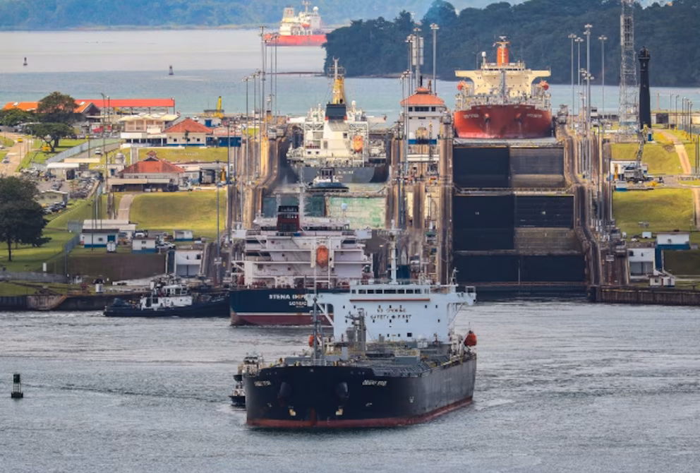 Aerial view of a busy shipping dock representing the updated Panama Canal Port Requirements for maritime terminal concessions.