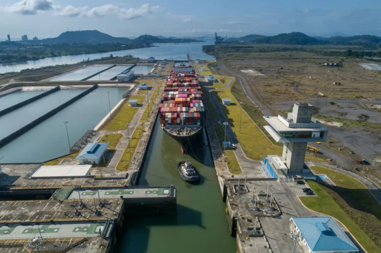 A large container ship navigating through the locks boosting Panama Canal revenue.