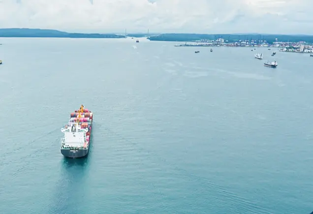 A large container ship navigating the Panama Canal representing the Panama maritime agreement and international shipping trade.