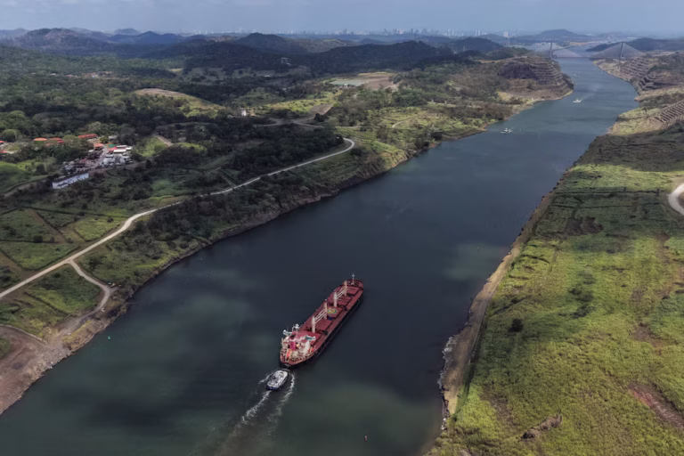 Container ship transiting locks demonstrating strong Panama Canal financial performance and maritime trade recovery.