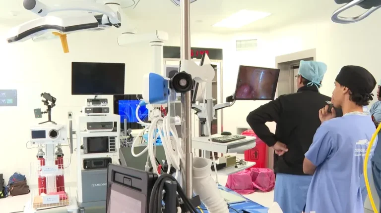 Medical team performing robotic telesurgery in Panama using remote console technology for gynecological procedures.