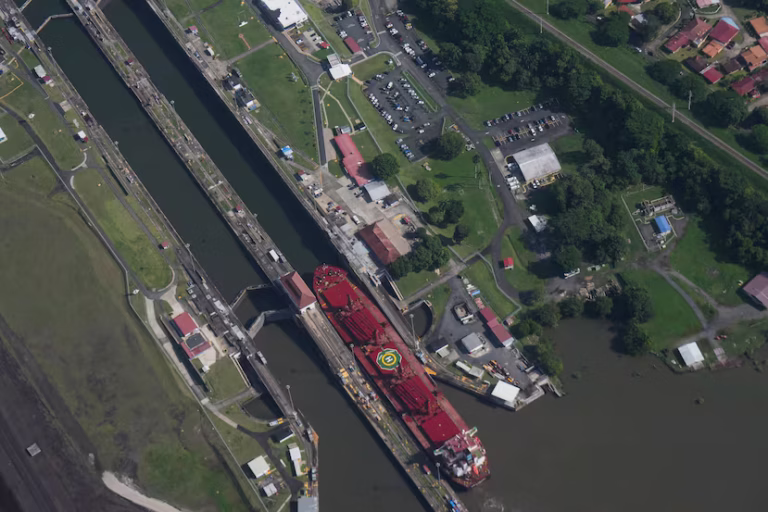 Container cargo ship navigating through the Panama Canal under strict transit limits during drought conditions