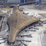 Passengers walking through the modern concourse undergoing the Tocumen airport expansion in Panama.
